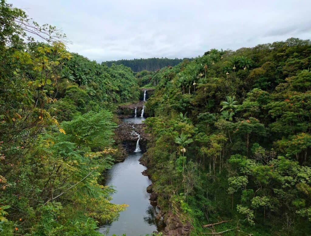 three tiered waterfall: umauma waterfalls. set amongst tropical forest on a cloudy day