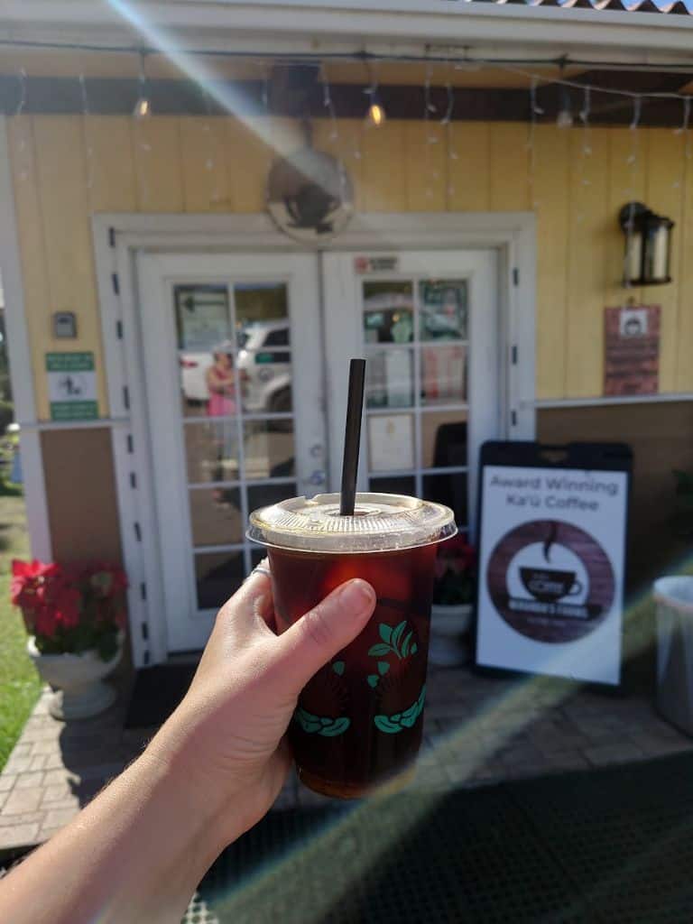 my hand holding Cold brew Ka'u coffee from Miranda's Coffee Farm