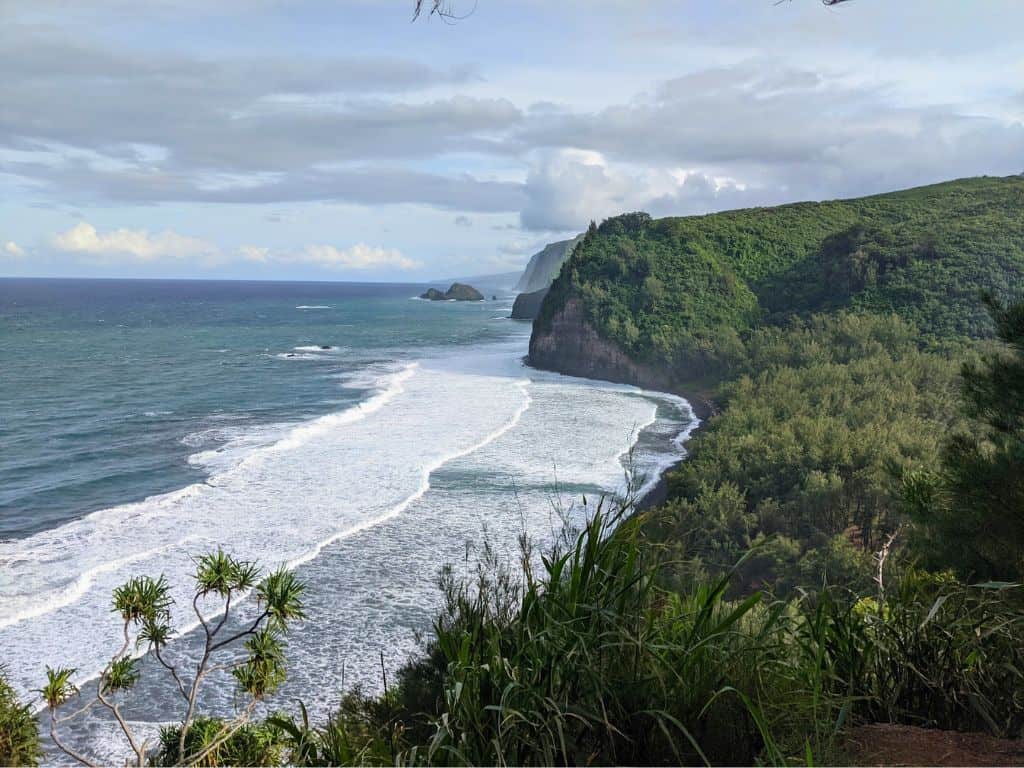 View of Pololu Valley from the parking lot with white capped waves and verdent valley