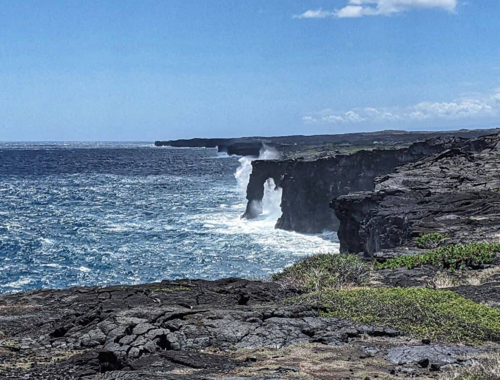 Holei Sea Arch and cliffs with waves crashing against it