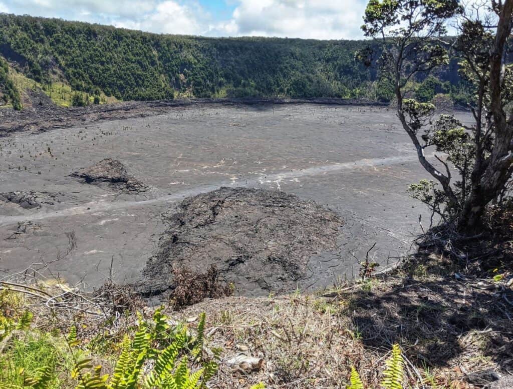 view looking down into Kilauea Iki Crater with hiking path going through it