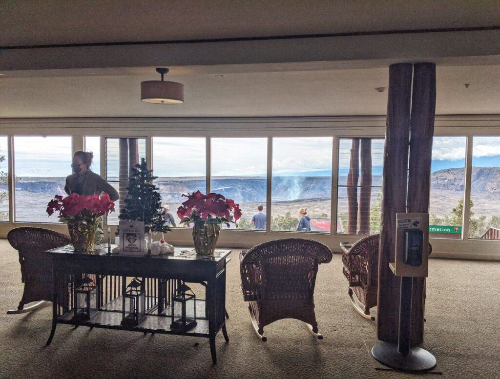 Lobby of Volcano House Hotel looking into Kilauea Crater with chairs in foreground
