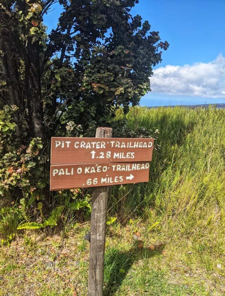 trail sign: pit crater trailhead .28 miles one way, pali o ka'eo trailhead .66 miles one way