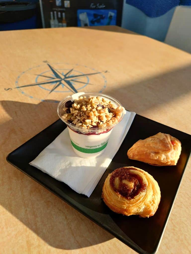 breakfast plate on tray with yogurt cup and pastries