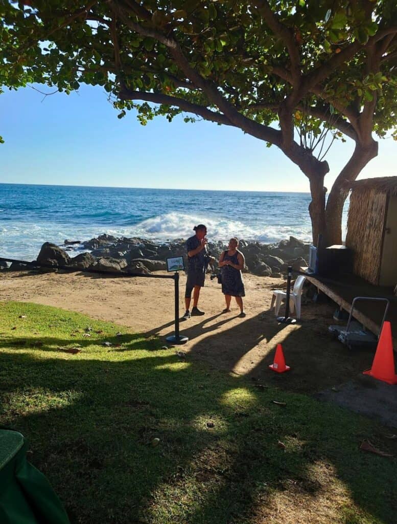 Luau photographers on the "beach" with wave and rocks in background