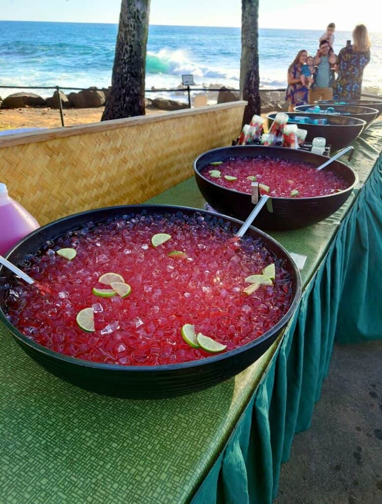 table with Non-alcoholic red fruit punch and water bottle bowls