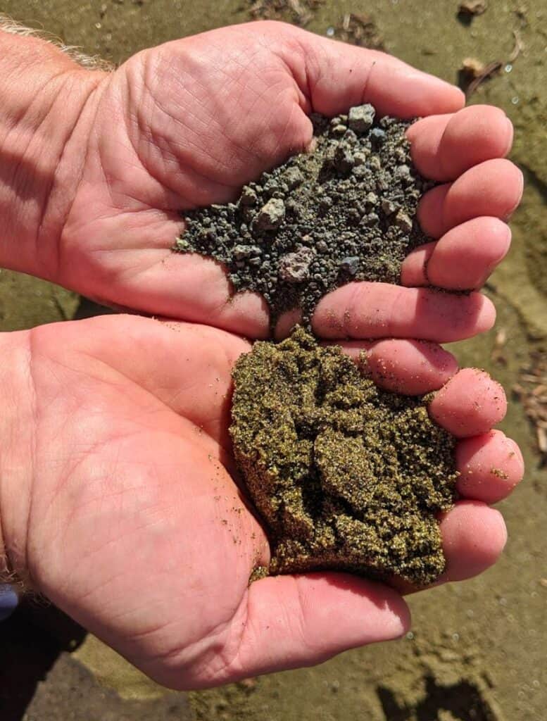 two hands Comparing green sand to grey gravel