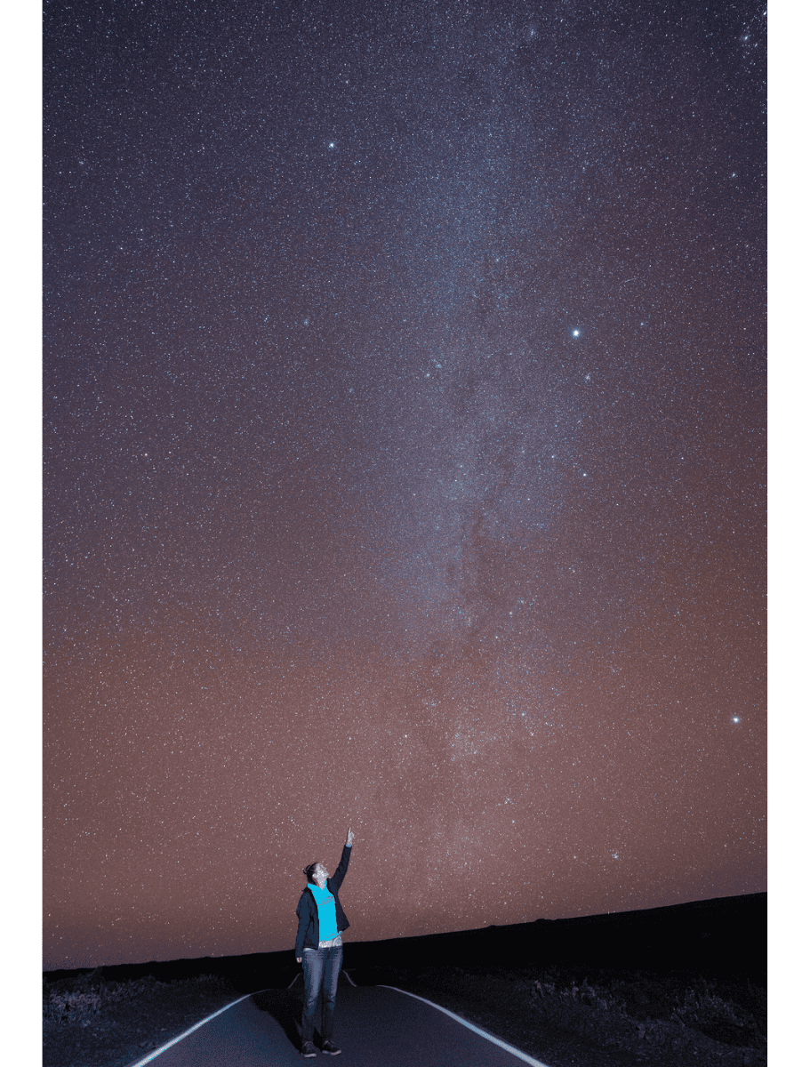 Me on a Mauna Kea pointing at the Milky Way