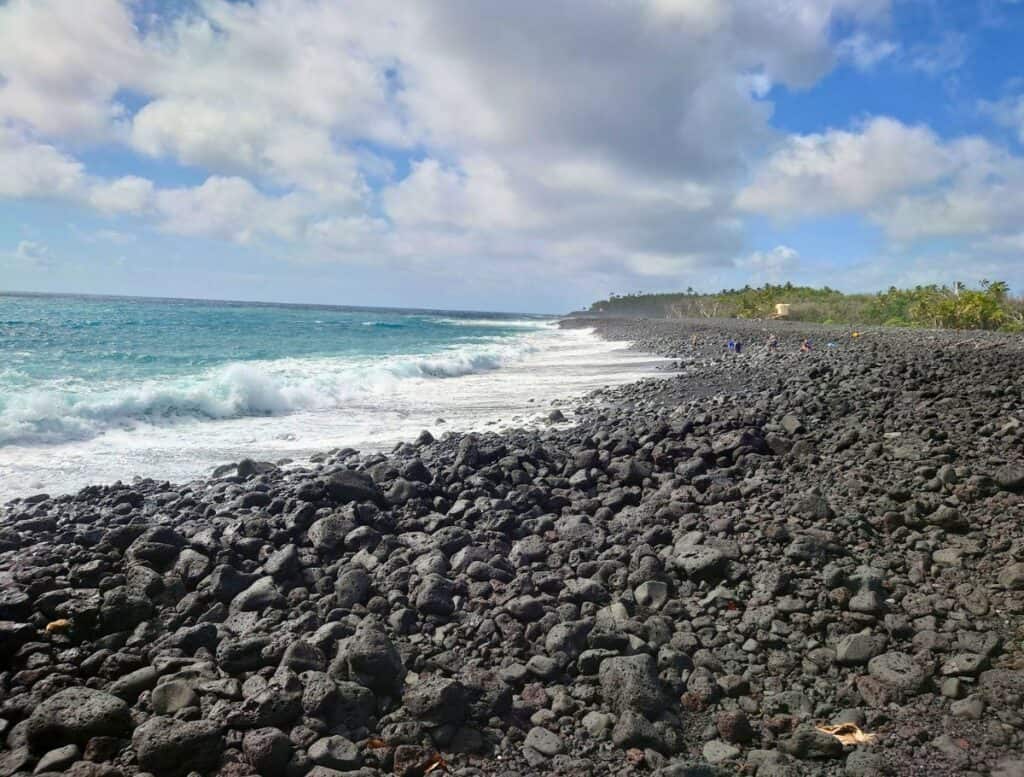 Rocky Pohoiki Black Sand Beach with blue waves crashing