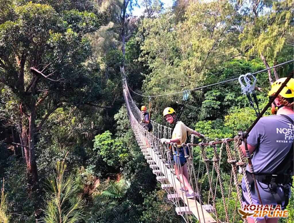 Me getting more comfortable on the wooden suspension bridges, this one having a single board crossing across the long bridge with a person in front of me and person behind me while we are over the forest