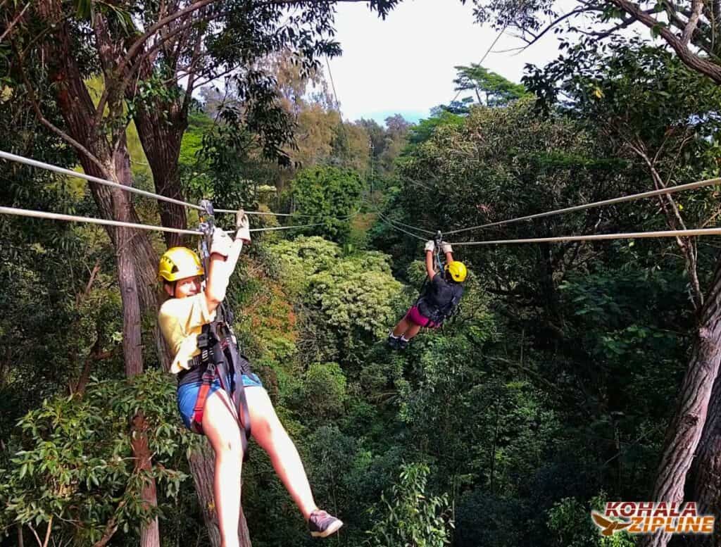 me on the left and girl on the right zipping the double zipline that's 1200ft long over a forest