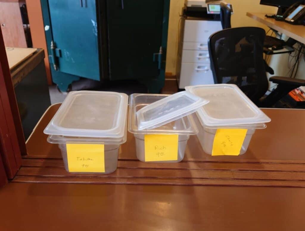 small clear Storage bins with lids for phone and keys at the front dest