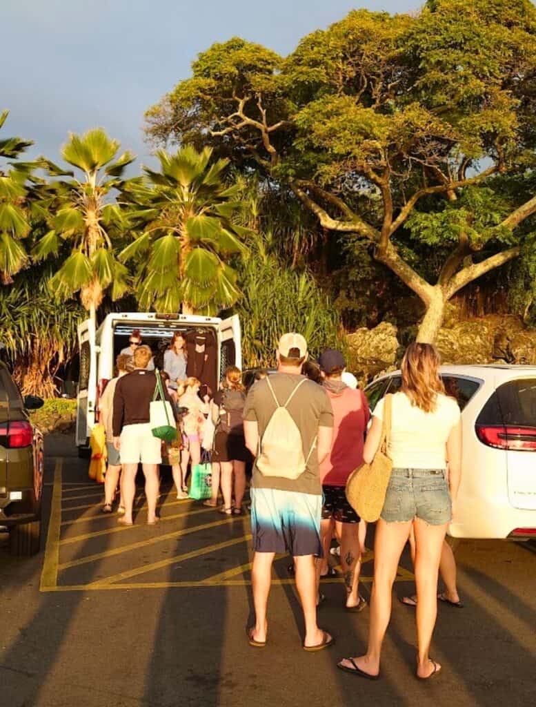 Line for the wet suit van, girls lined on the right and boys on the left
