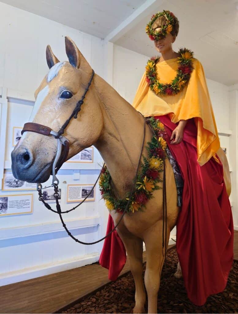 Pā‘ū rider display at the Pukalani Stables museum: women in fancy garb on horse statue