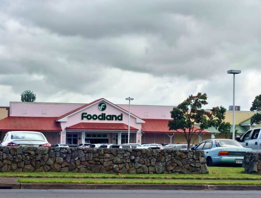exterior of Foodland grocery store in Waimea with rock wall in foreground