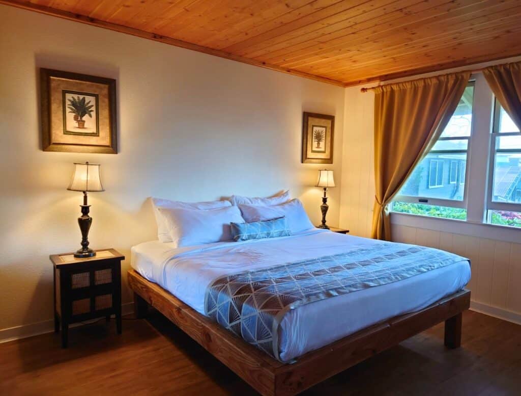 First floor King room with lit lamps on the bedside tables