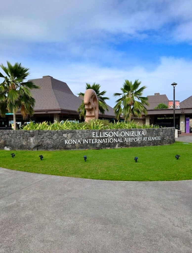 ellison onizuka kona international airport at keahole sign with modern hale buildings in background