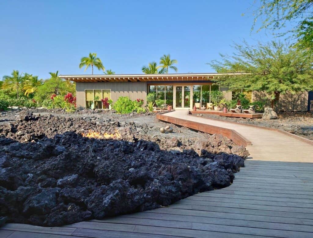 Asaya Spa entrance with wooden boardwalk over lava