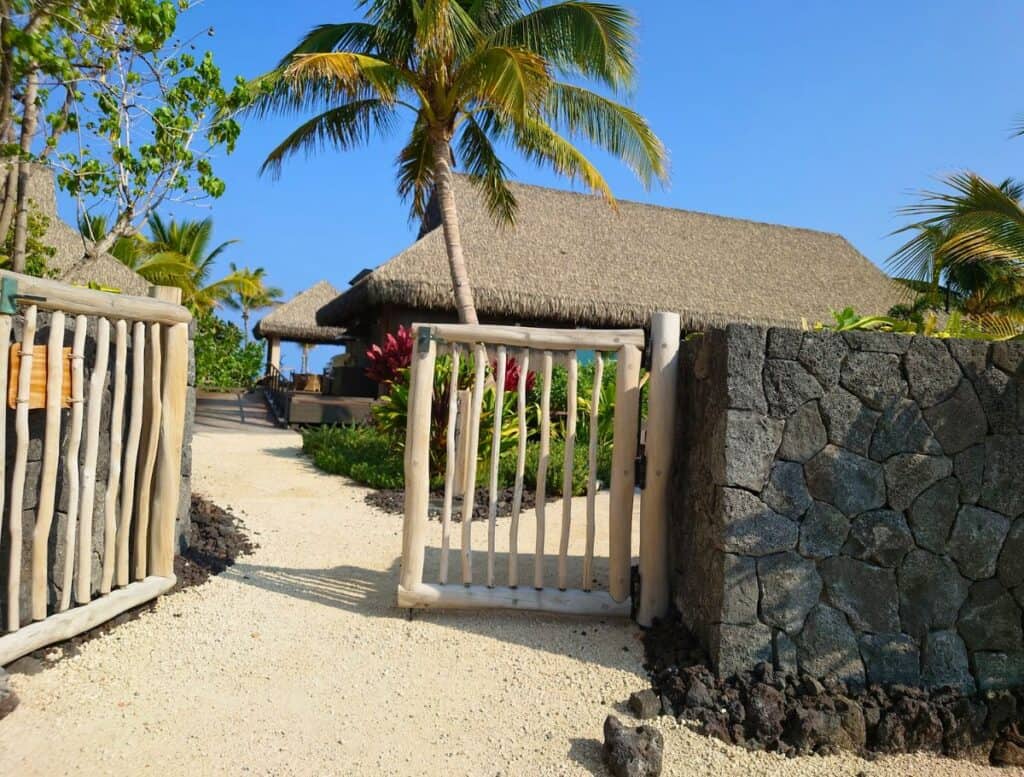 hale entrance with wood gate and stone fence
