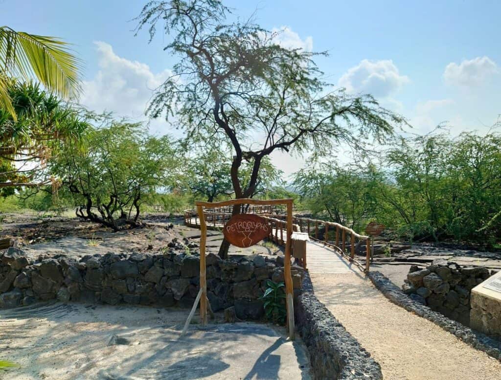 entrance to petroglyph field with wooden walkway over lava