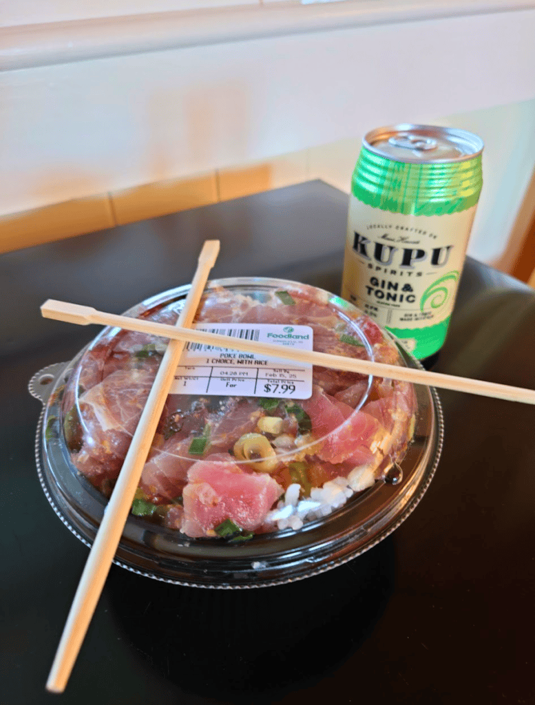 Cheap poke bowl from grocery store with chopsticks crossed over it and can of kupu gin and tonic