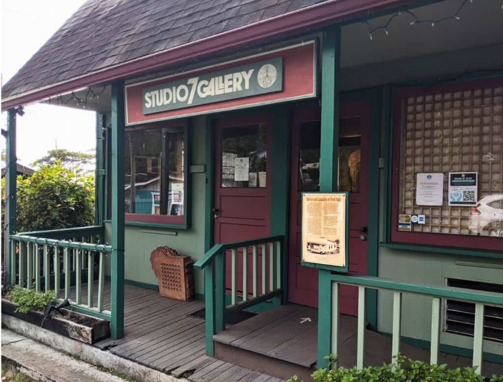 Studio 7 Gallery front porch, building is green and red