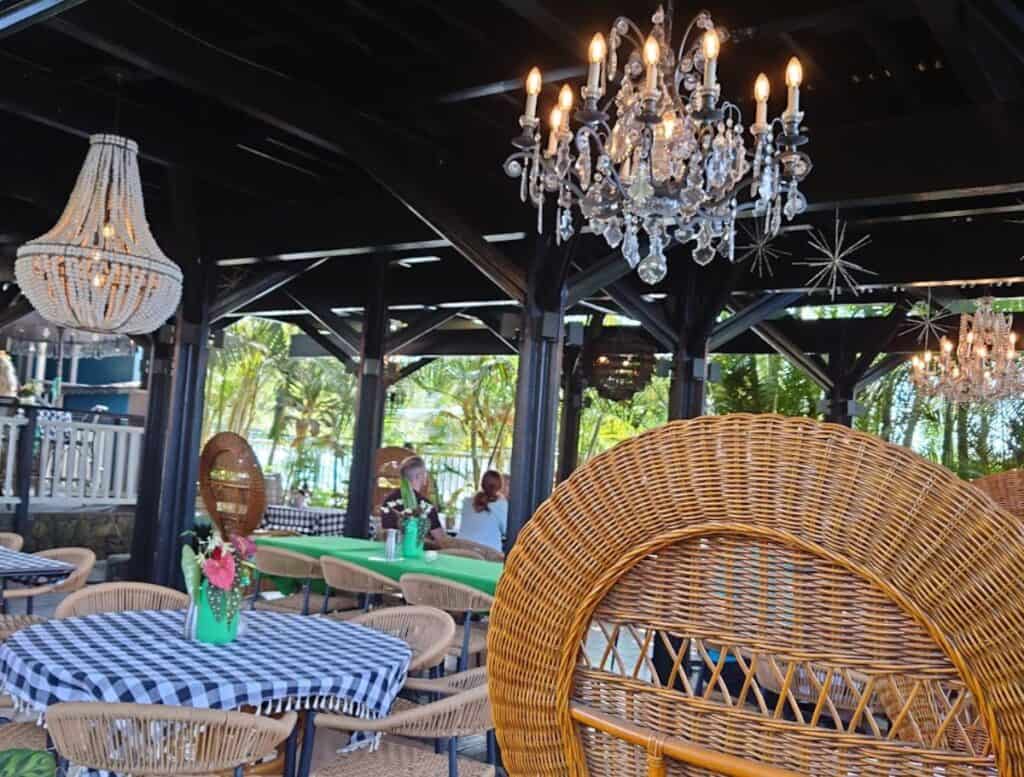 Holualoa Garden and Kitchen dining under a carport with chandeliers hanging