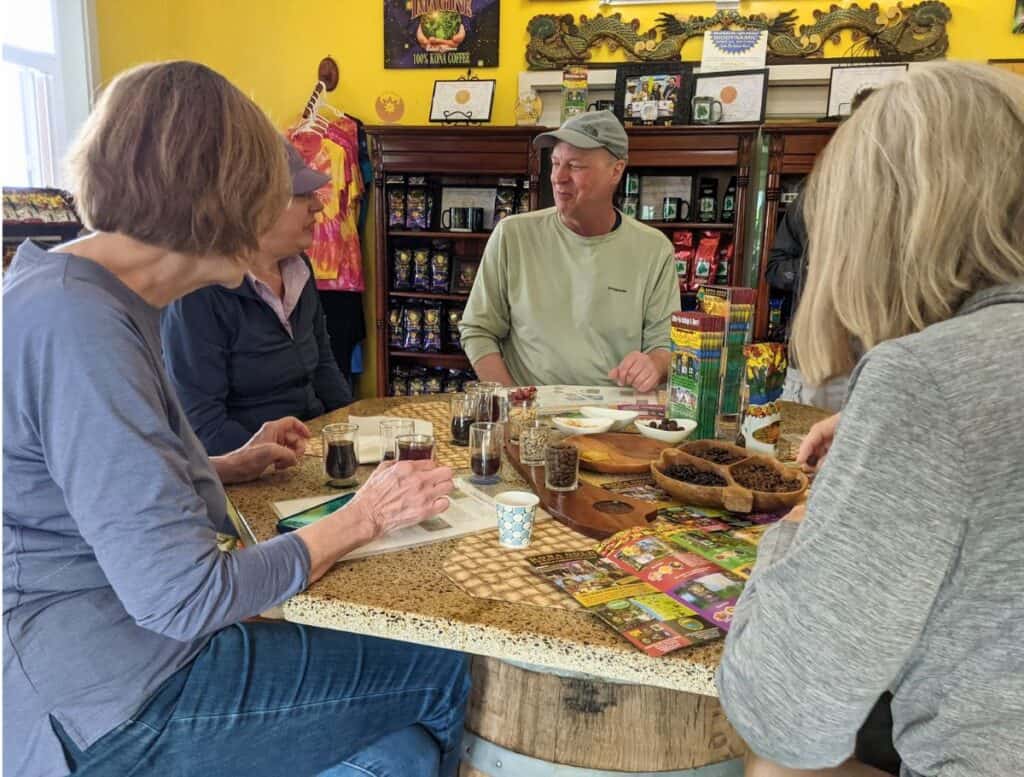 people around a table Coffee tasting at Buddha's Cup