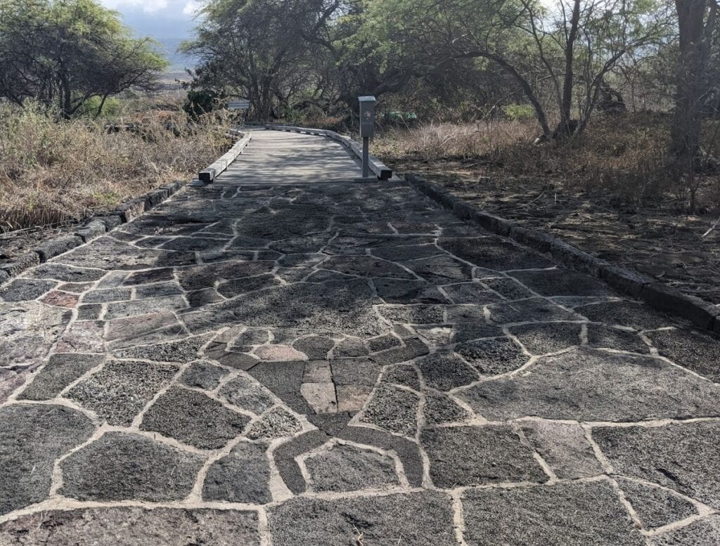 Entrance to Kaloko-Honokōhau National Historical Park petroglyph boardwalk with mosaic petroglyph