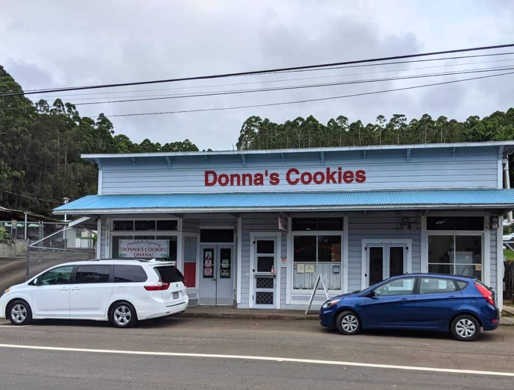 Donna's Cookies blue exterior of building with cars parked parallel in front of it