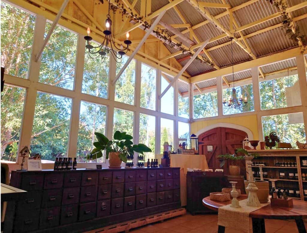 Hawaiian Vanilla Co gift shop with wooden file cabinet, large windows and products for sale
