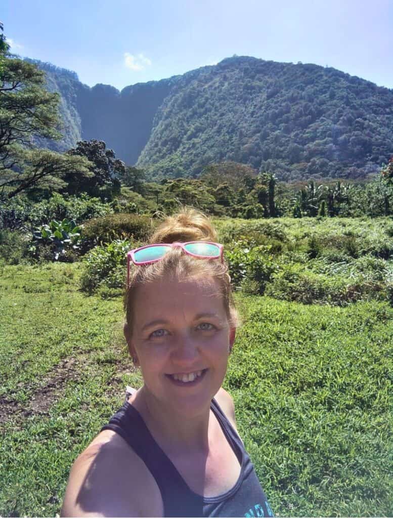 Me trying to take a selfie with Hi'ilawe Falls, which is covered by shade. just lush mountains instead