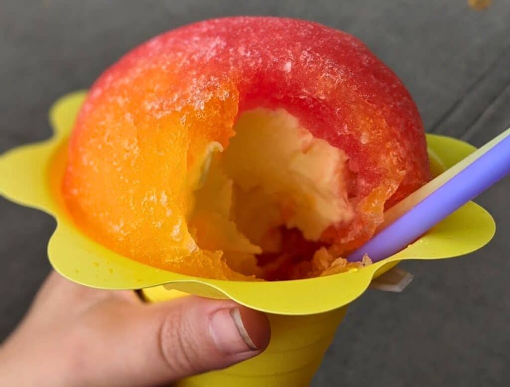 red and orange Scandanavian Shave Ice with Dole Whip center in yellow cup
